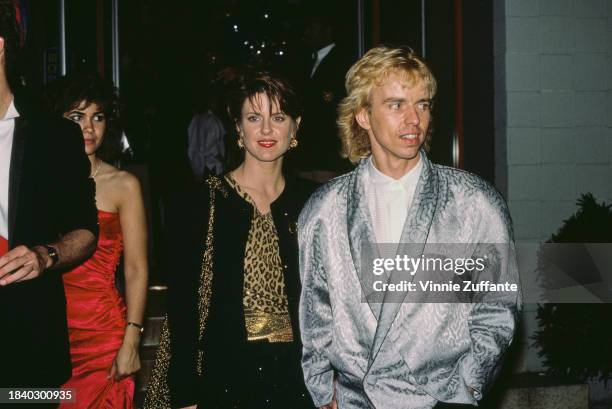 American actress Pam Dawber, wearing a black jacket over a black-and-gold outfit, and American singer, songwriter and guitarist Tommy Shaw, wearing a...