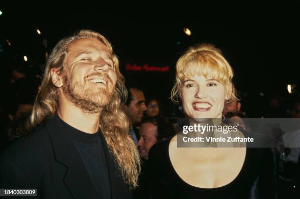 Finnish film director Renny Harlin and his wife, American actress Geena Davis, attend the Hollywood premiere of 'Demolition Man', held at the Mann...