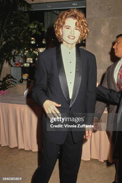 American actress Geena Davis, wearing a black tuxedo over a white shirt with black buttons, attends the 44th Annual Directors Guild Awards, held at...