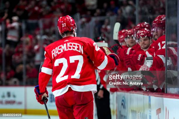 Michael Rasmussen of the Detroit Red Wings high fives teammates after scoring a goal against the San Jose Sharks at Little Caesars Arena on December...