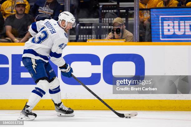 Darren Raddysh of the Tampa Bay Lightning skates with the puck against the Nashville Predators during the first period at Bridgestone Arena on...