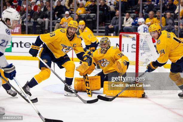 Roman Josi and Gustav Nyquist skate as Juuse Saros of the Nashville Predators tends net against the Tampa Bay Lightning during the second period at...