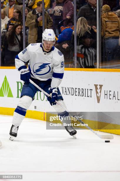 Mikhail Sergachev of the Tampa Bay Lightning skates with the puck against the Nashville Predators during the first period at Bridgestone Arena on...