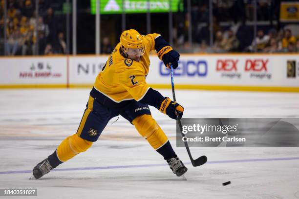 Luke Schenn of the Nashville Predators takes a shot against the Tampa Bay Lightning during the first period at Bridgestone Arena on December 7, 2023...