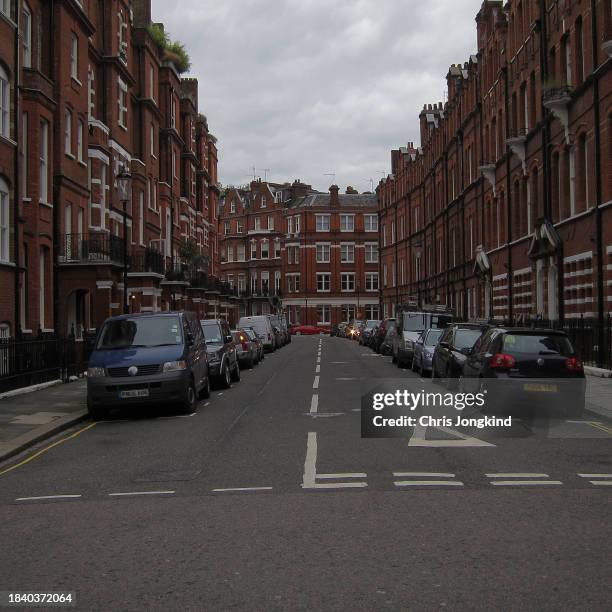 cars parked on both sides of narrow residential street - square stock pictures, royalty-free photos & images