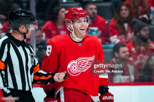 Patrick Kane of the Detroit Red Wings laughs with referee Brian Pochmara during the game against the San Jose Sharks Little Caesars Arena on December...