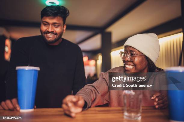 group of friends enjoying refreshing drink during gaming brake - microsoft media & entertainment group stock pictures, royalty-free photos & images