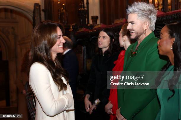 Catherine, Princess of Wales speaks with Adam Lambert at The "Together At Christmas" Carol Service at Westminster Abbey on December 08, 2023 in...