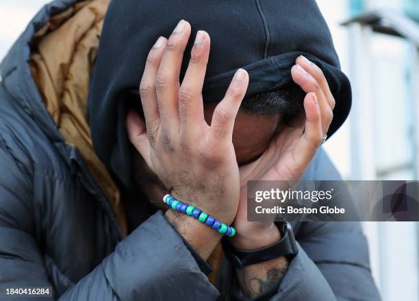 Cambridge, MA An emotional Manuel Asprilla-Hassan wears his brother Roderick Jackson's bracelet as he cries on the step of his mother's home....