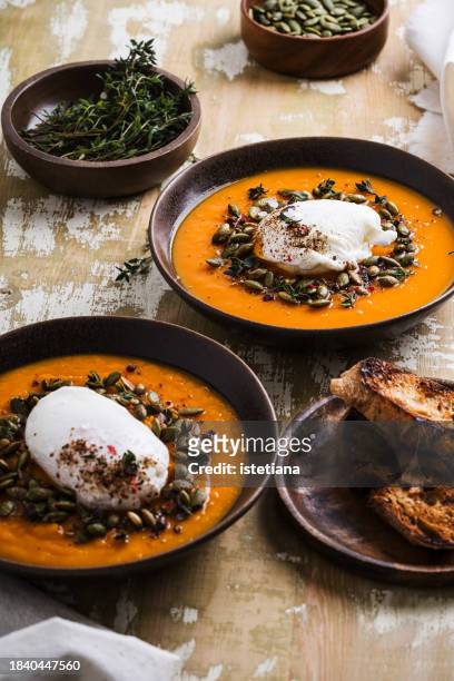 pumpkin soup with poached egg, healthy autumn vegetarian comfort food - winter vegetables stock pictures, royalty-free photos & images