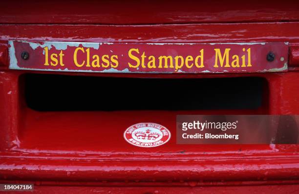 Save Our Royal Mail" sticker sits on a Royal Mail Group Ltd. First class mail box at the company's postal sorting office in Romford, U.K., on Friday,...