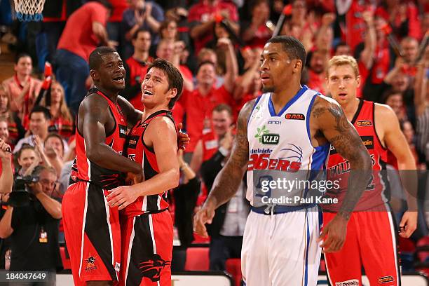 James Ennis and Damian Martin of the Wildcats celebrate winning the round one NBL match between the Perth Wildcats and the Adelaide 36ers at Perth...