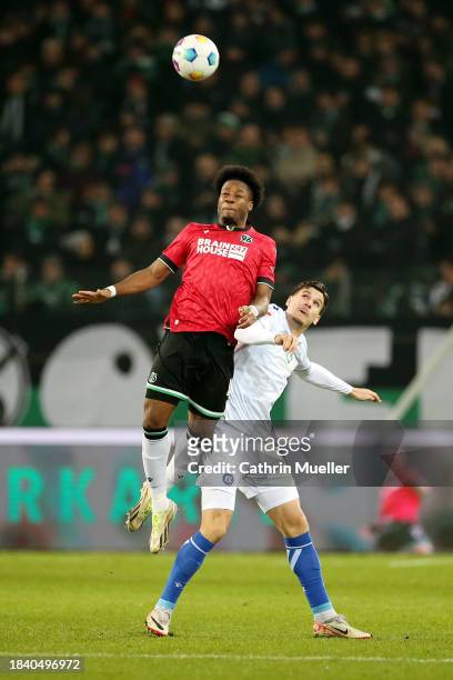 Bright Arrey-Mbi of Hannover 96 and Igor Matanovic of Karlsruher SC battle for a header during the Second Bundesliga match between Hannover 96 and...