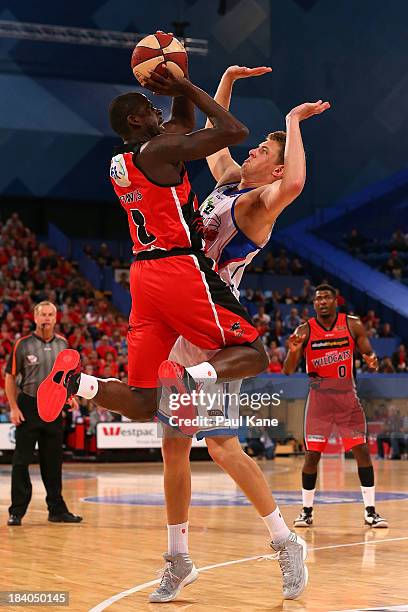 James Ennis of the Wildcats shoots against Daniel Johnson of the 36ers during the round one NBL match between the Perth Wildcats and the Adelaide...