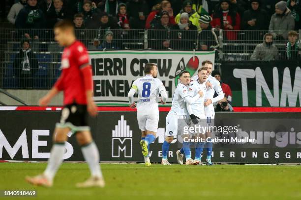 Karlsruher SC players celebrate their team's first goal, an own goal scored by Marcel Halstenberg of Hannover 96 during the Second Bundesliga match...