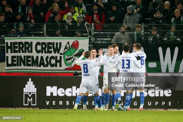 Karlsruher SC players celebrate their team's first goal, an own goal scored by Marcel Halstenberg of Hannover 96 during the Second Bundesliga match...