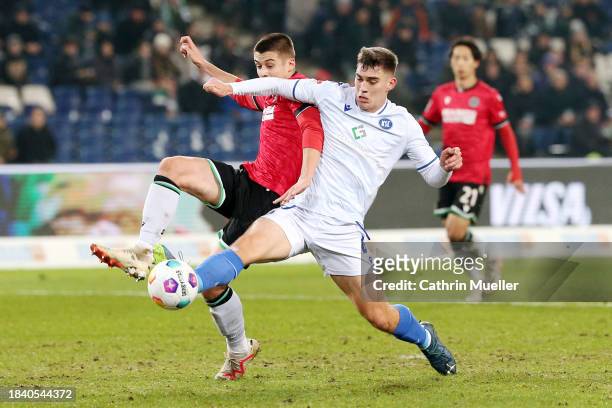 Nicolo Tresoldi of Hannover 96 and Marcel Beifus of Karlsruher SC battle for the ball during the Second Bundesliga match between Hannover 96 and...