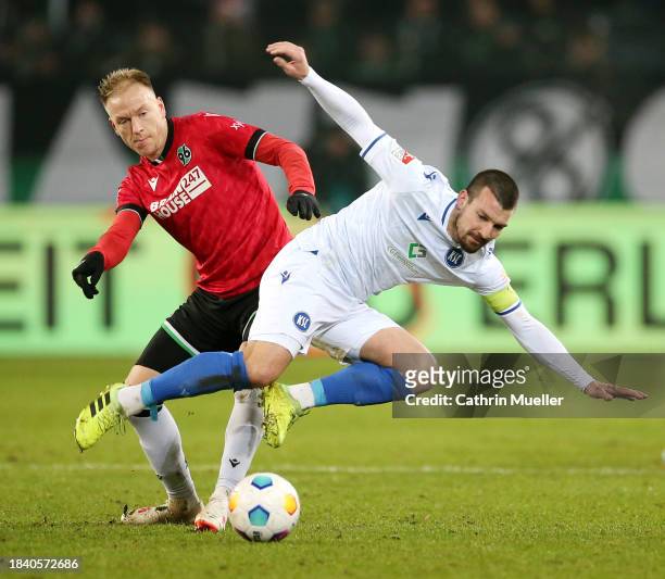 Haavard Nielsen of Hannover 96 and Jerome Gondorf of Karlsruher SC clash during the Second Bundesliga match between Hannover 96 and Karlsruher SC at...