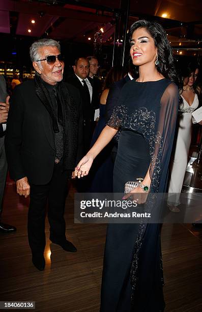 Fashion designer Roberto Cavalli and Princess Ameera al-Taweel attend the gala dinner at the Armani Pavilion during Vogue Fashion Dubai Experience on...