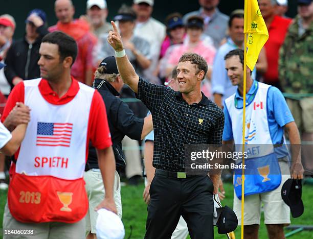 Graham DeLaet of the International Team celebrates his birdie chip from a bunker on the 18th green during the final round of The Presidents Cup at...