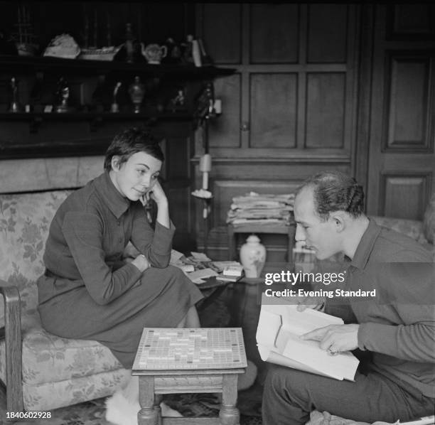 Stirling Moss plays scrabble with his wife Katie Moss in their living room, May 20th 1958.