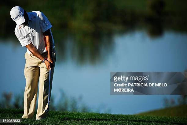 Chilean golfer Felipe Aguilar putts to the 11th hole during the second day of the Portugal Masters golf tournament at Victoria Golf Course in...