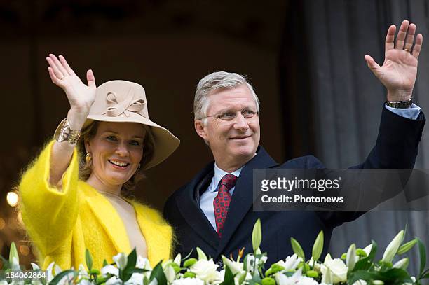 King Philippe and Queen Mathilde of Belgium wave to wellwishers during their visit to the city of Liege as part of the royal couple's tour of the...