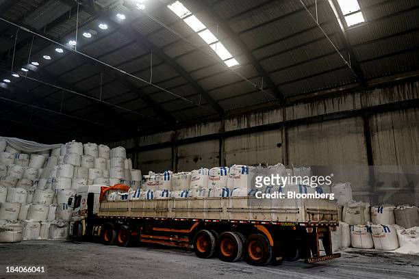 Bags of sugar sit on a flatbed truck at Unidade Industrial Cruz Alta da Guarani SA's processing plant, near Sao Jose do Rio Preto, Brazil, on...