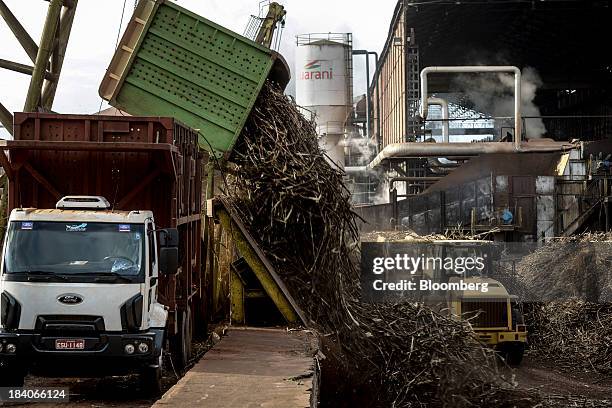 Sugarcane stalks are unloaded to be crushed at Unidade Industrial Cruz Alta da Guarani SA's processing plant, near Sao Jose do Rio Preto, Brazil, on...