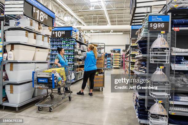 Miami, Hialeah Gardens, Florida, Walmart Supercenter, customer with shopping cart talking with employee.