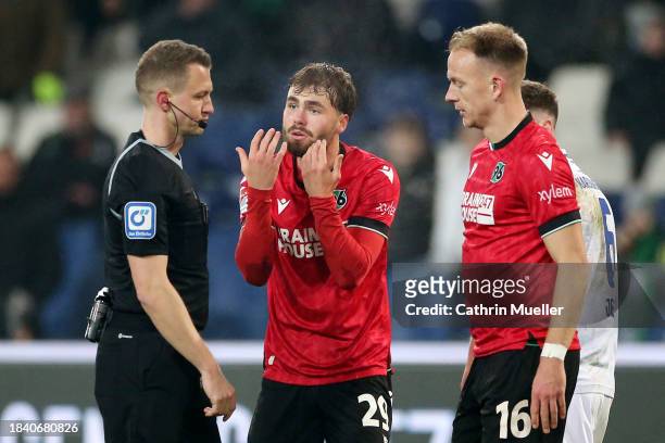 Kolja Oudenne of Hannover 96 speaks with Match Referee, Florian Lechner during the Second Bundesliga match between Hannover 96 and Karlsruher SC at...