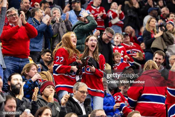 Fans in the crowd celebrate after a goal during the second period of the NHL regular season game between the Montreal Canadiens and the Seattle...