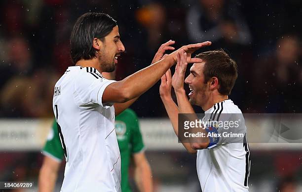 Sami Khedira of Germany celebrates his team's first goal with team mate Philipp Lahm during the FIFA 2014 World Cup Group C qualifiying match between...