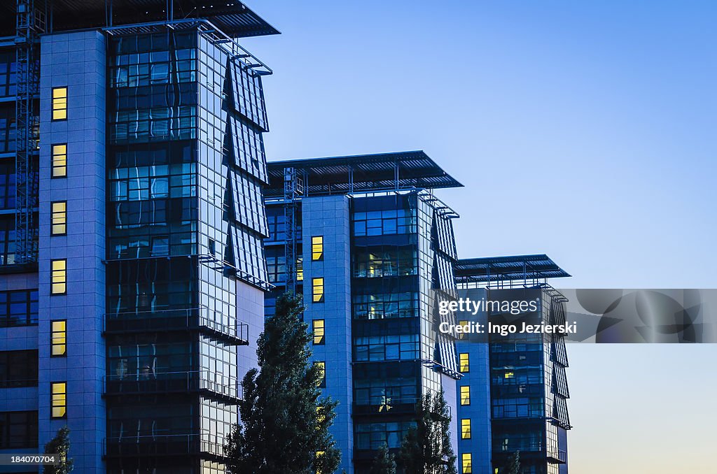 Three modern office buildings with glass facade