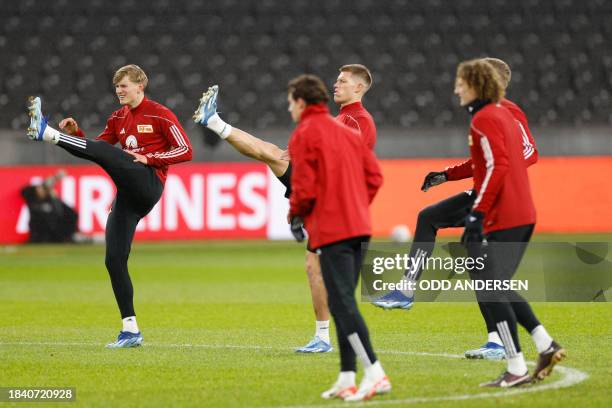 Union Berlin's players warm up prior a training session in Berlin on December 11 on the eve of their UEFA Champions League Group C match against Real...