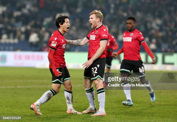 Sei Muroya of Hannover 96 celebrates scoring his team's second goal with teammate Andreas Voglsammer during the Second Bundesliga match between...