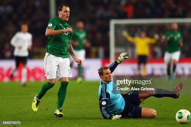 Anthony Stokes of Ireland is challenged by goalkeeper Manuel Neuer of Germany during the FIFA 2014 World Cup Group C qualifiying match between...