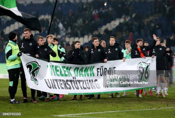 Hannover 96 players display a banner thanking fans for their support following the Second Bundesliga match between Hannover 96 and Karlsruher SC at...