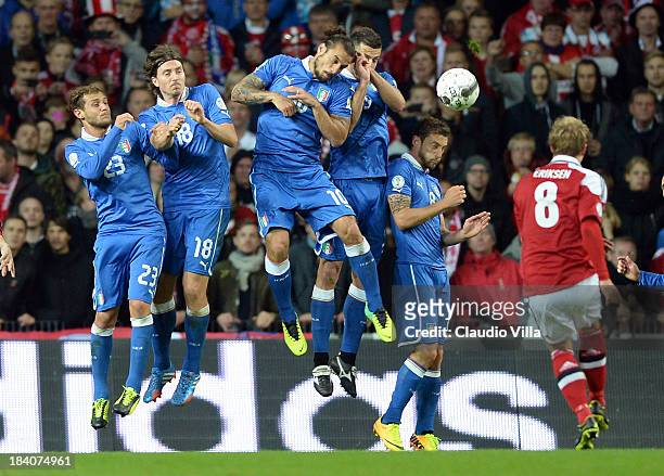 Christian Eriksen of Denmark puts his free kick into the Italy wall during the FIFA 2014 world cup qualifier between Denmark and Italy on October 11,...