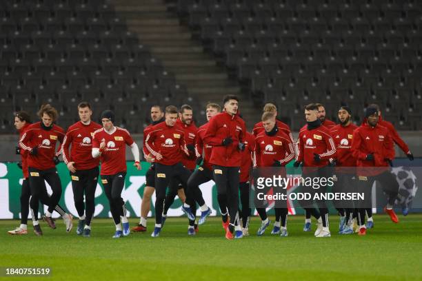 Union Berlin's players warm up prior a training session in Berlin on December 11 on the eve of their UEFA Champions League Group C match against Real...