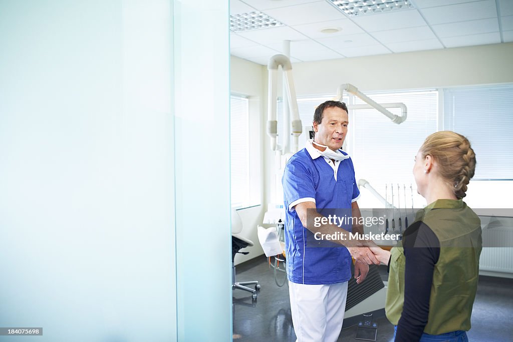 Dentist welcoming a patient