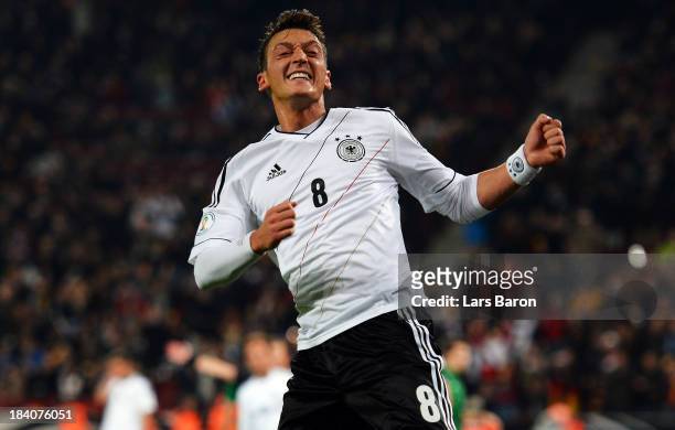 Mesut Oezil of Germany celebrates after scoring his teams third goal during the FIFA 2014 World Cup Qualifying Group C match between Germany and...