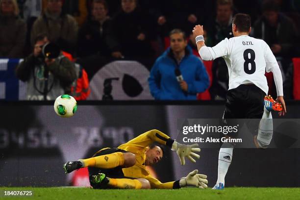 Mesut Oezil of Germany scores his team's third goal against goalkeeper David Forde of Ireland during the FIFA 2014 World Cup Group C qualifiying...