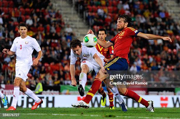 Michu of Spain shoots towards goal under a challenge by Balanovich of Belarus during the FIFA 2014 World Cup Qualifier match between Spain and...