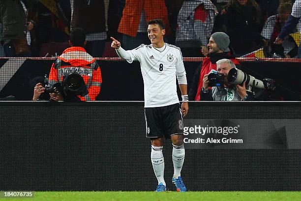 Mesut Oezil of Germany celebrates his team's third goal during the FIFA 2014 World Cup Group C qualifiying match between Germany and Republic of...