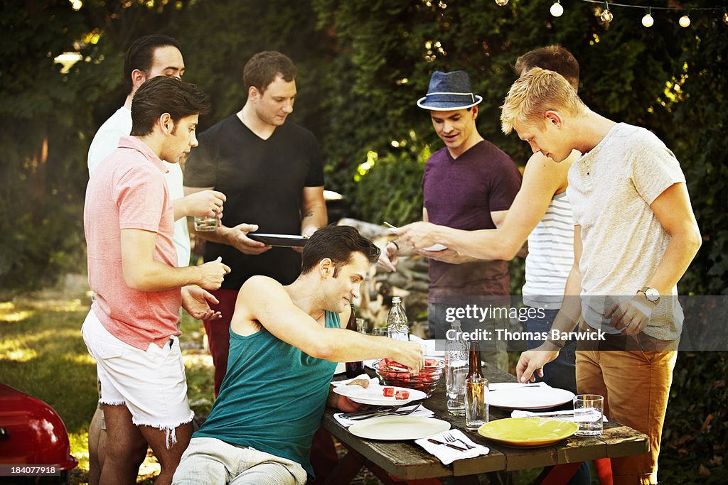 Group of gay men having a backyard barbecue