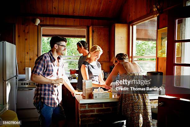 Group of friends preparing a meal in rustic cabin