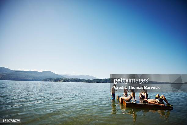 group of friends hanging out on floating dock - hopptorn bildbanksfoton och bilder