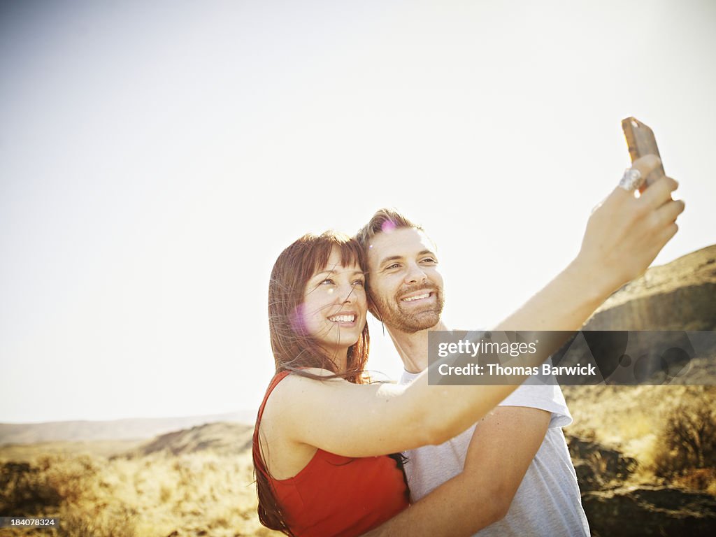 Couple taking self portrait with smartphone