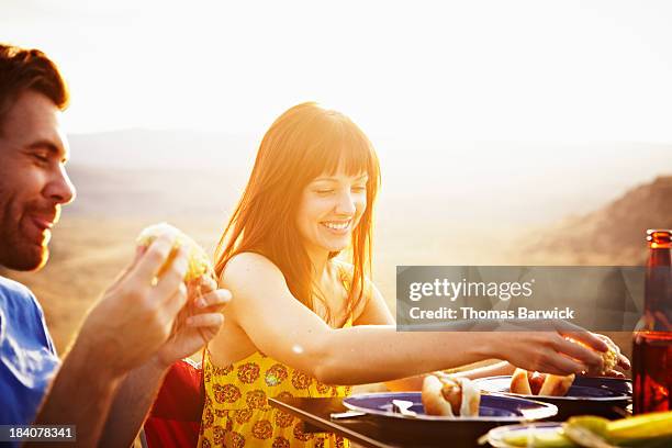smiling couple dining at table at sunset - romantic dining stock pictures, royalty-free photos & images